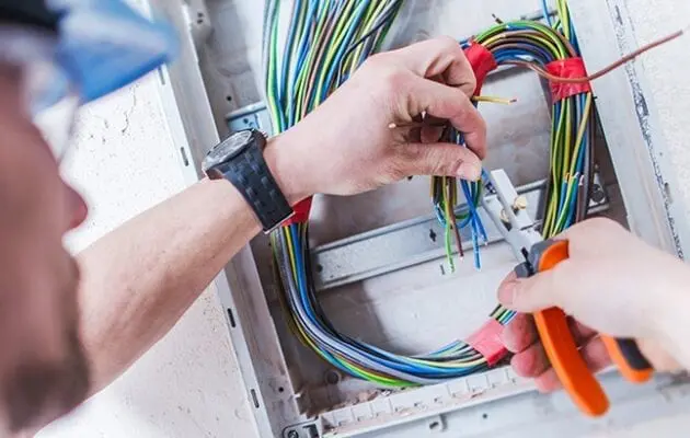 Electrician repairing electrical box