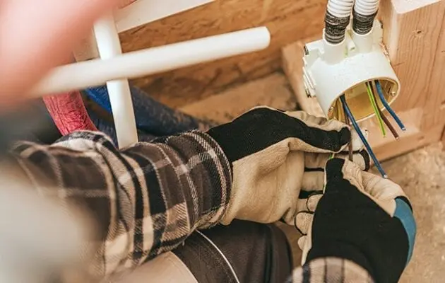 Electrician working on electrical conduit