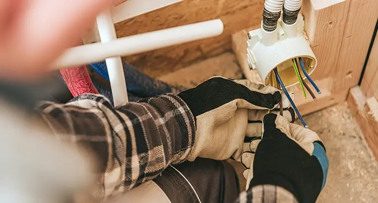 Electrician working on electrical conduit