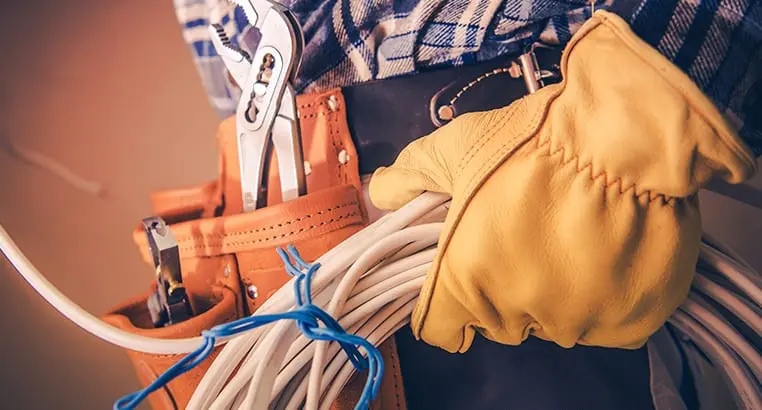 Electrician carrying bundle of cables