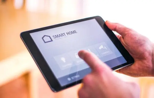 Person interacting with a smart home app on a tablet