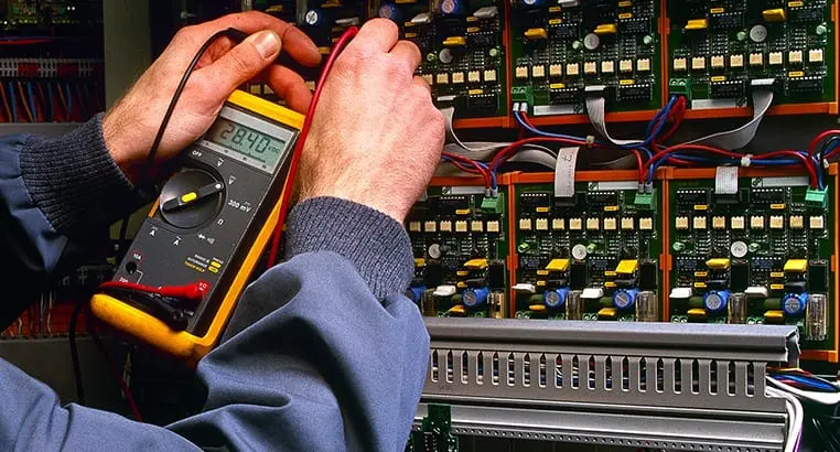 Electrician taking readings from electrical pannels